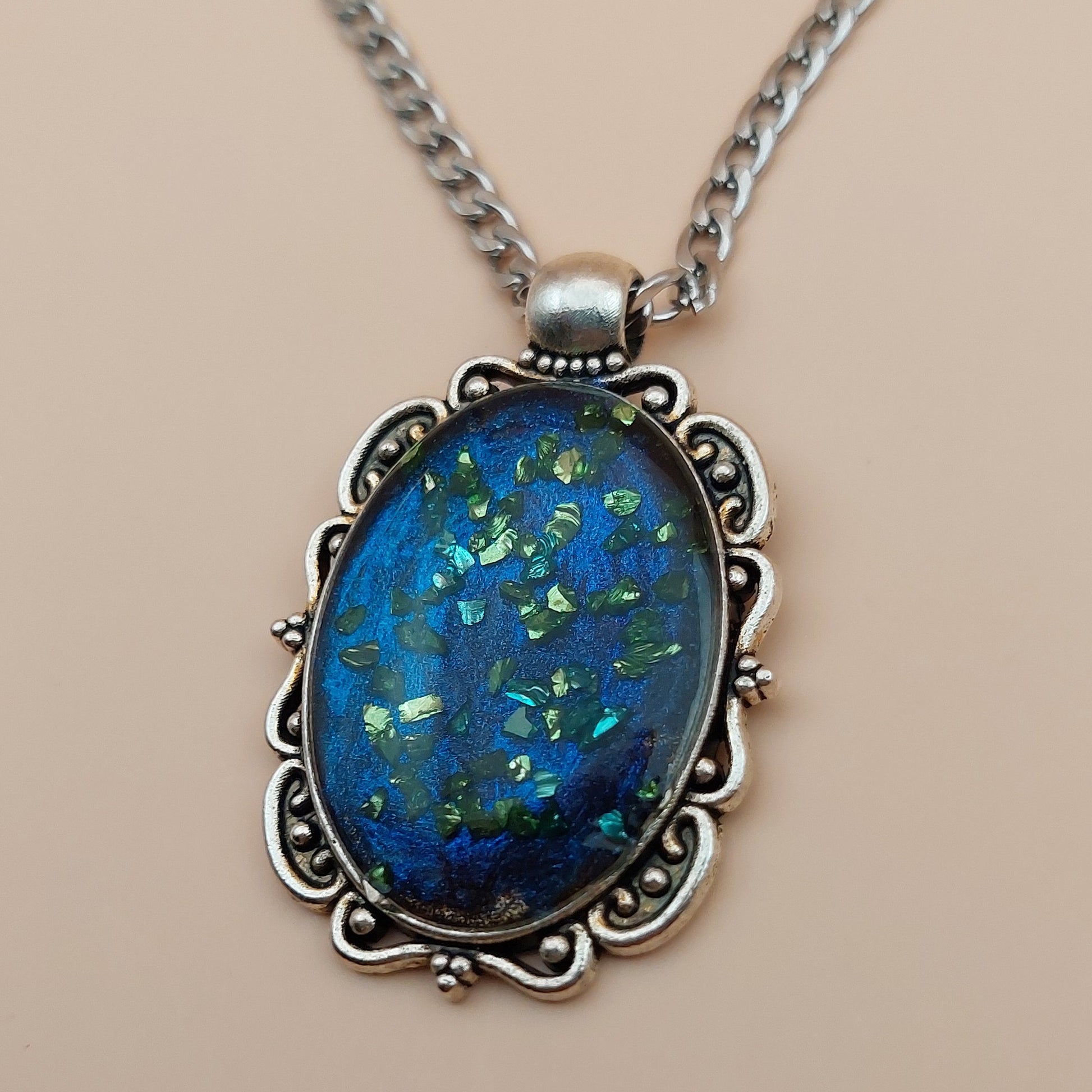 Necklace with a blue pendant on a beige background