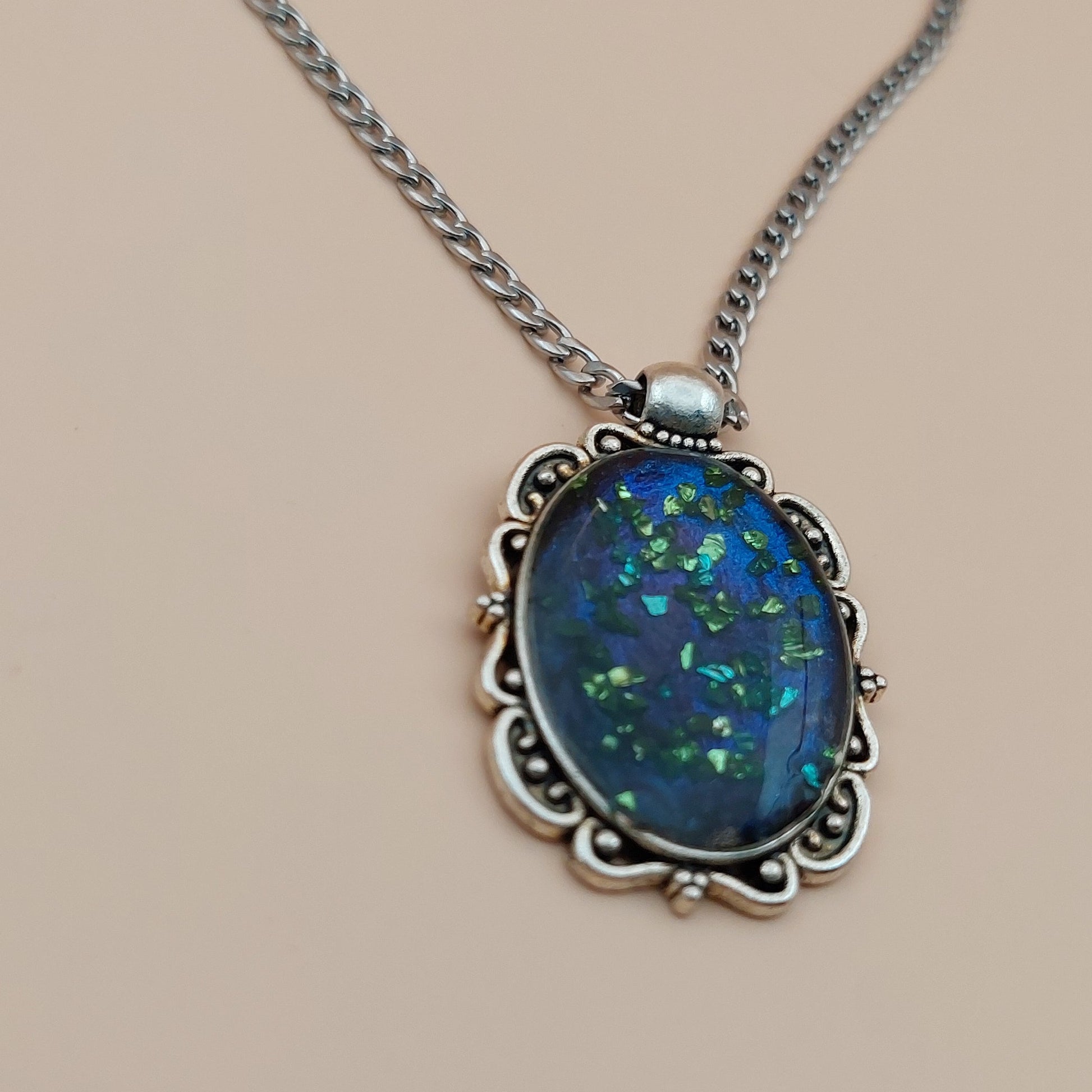 Necklace with a blue gemstone pendant on a beige background